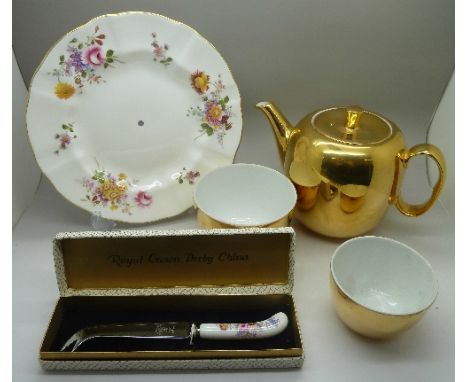 A Royal Crown Derby, Derby Posies cake stand, a Royal Crown Derby Derby Posies cheese knife and a Royal Worcester gold teapot