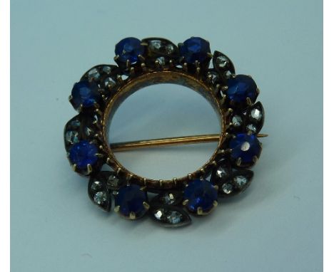 A blue stone and diamond circular brooch, weight 4.7g