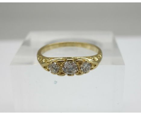An 18ct gold and diamond three stone ring, weight 2.8g, size K