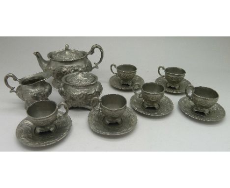A children's miniature pewter tea service