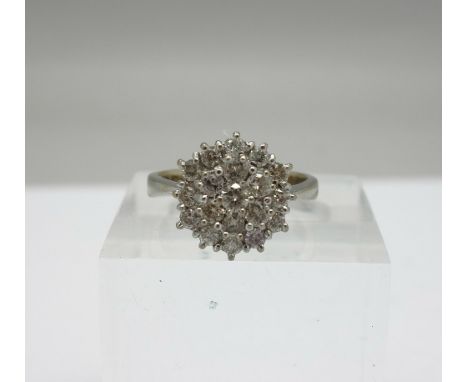 An 18ct white gold and diamond cluster ring, weight 5.2g, size M