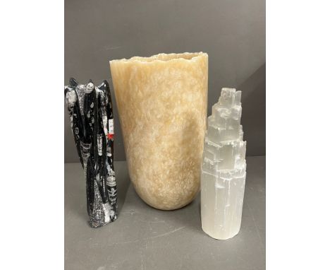 A large cylindrical vase and fossil style sculptures 