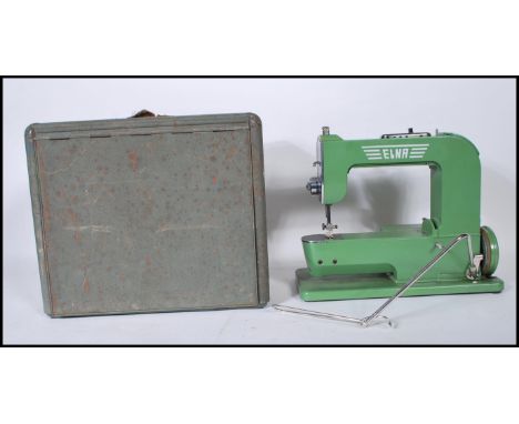 A vintage 1940's Elna 'Grasshopper' sewing machine in original green paint, within a fitted metal metamorphic case, marked ty