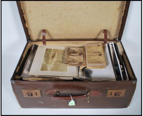 A Vintage Cowhide leather suitcase containing hundreds of black &amp; white photographs. Sizes range from small snapshot to v