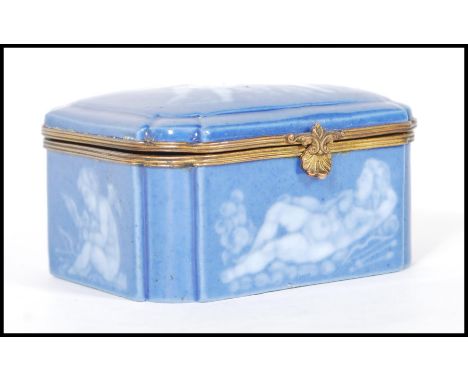 An early 20th Century continental German porcelain blue ceramic casket / trinket box with a pat sur-pat design featuring cher