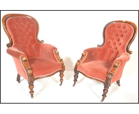 A pair of 19th Century Victorian walnut framed spoonback library / lounge chairs, both upholstered in salmon velour, button b
