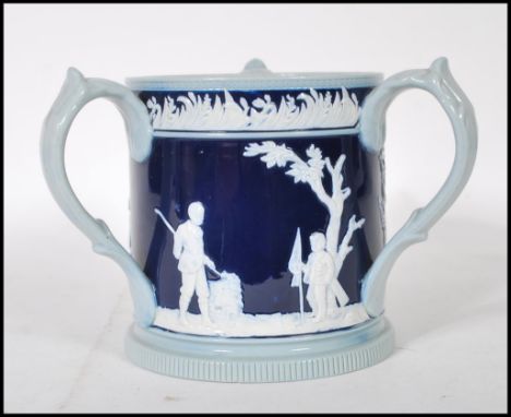 Golfing Interest- A early 20th Century Copeland Late Spode loving cup having a dark blue cobalt ground body with figures rais