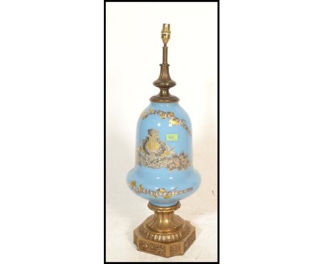 A large antique style bulbous blue glass and brass table lamp. Of Neo classical design on blue ground having brass plinth and