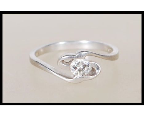 A 950 platinum solitaire diamond ring having an openwork swirl mount set with a single diamond stone. Approx 20pts. Stamped P