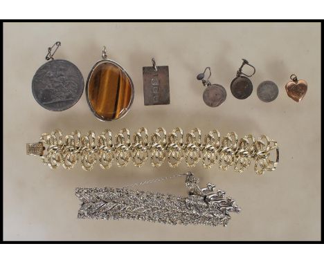 A small collection of vintage costume jewellery and silver jewellery items dating from the 19th Century to include a Queen Vi