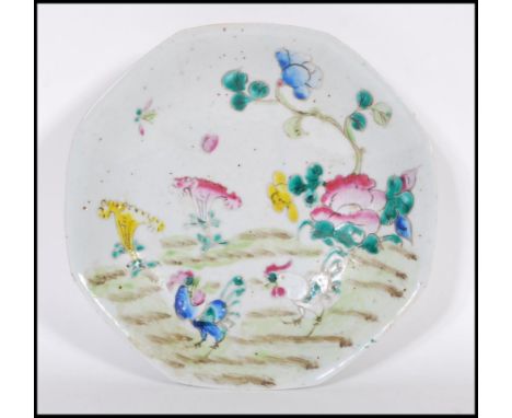 A 19th century Chinese ceramic Wucai footed dish of octagonal form being hand painted and enameled with floral sprays and two