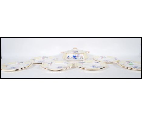 A vintage Art Deco 1930's dinner service having a paneled yellow Clarice Cliff style crocus pattern consisting of tureen cons