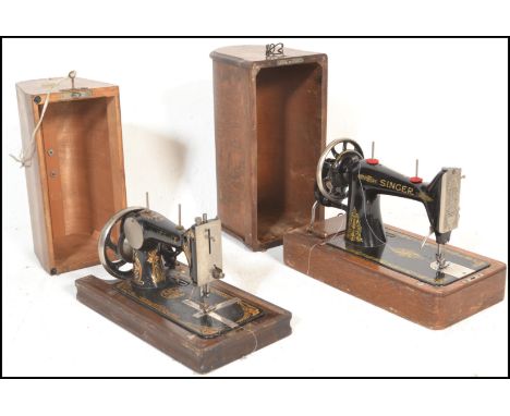 Two early 20th Century oak cased hand crank manual sewing machines,the first by Singer and the other named The Service each d