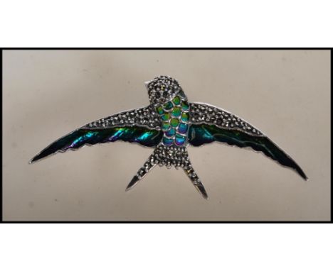 A stamped 925 silver and marcasite brooch pendant in the form of a swallow bird having enamel plique a jour detailing with pi