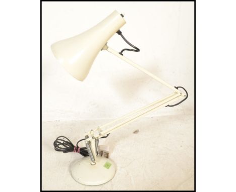 A vintage retro mid 20th Century anglepoise desk lamp by Herbert Terry raised on a white round base with pendant light shade 