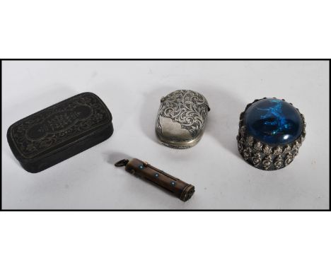 A selection of tools and cases to include a Georgian ebonised snuff box having scrolled foliate decoration, a stamped 800 sil