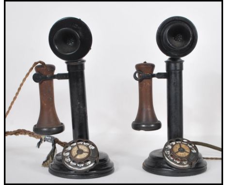 A pair of early 20th Century vintage automatic stick telephones constructed from ebonised cast iron and having rotary dials, 