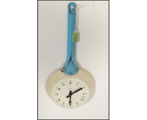 A retro mid 20th Century 1950's metal wall clock by Paico in the form of a frying pan having blue enamelled handle with the w