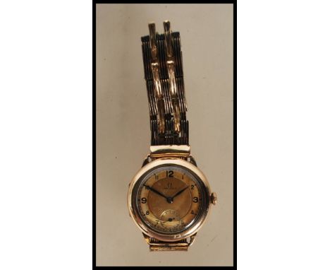 A vintage 1930's 15 jewels Omega gentleman's gold plated wrist watch having a round gilt face with arabic numerals to the cha