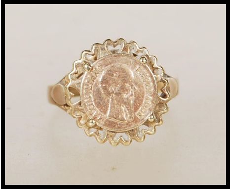 A hallmarked 9ct gold ring set with a 1865 Mexican gold coin. Hallmarked London. Weight 2.3g. Size N.