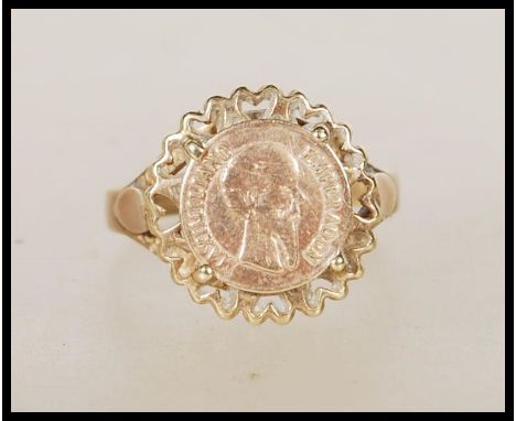 A hallmarked 9ct gold ring set with a 1865 Mexican gold coin. Hallmarked London. Weight 2.3g. Size N.