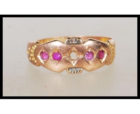 A hallmarked Victorian 15ct gold ring set with four round cut red stones (one missing). Hallmarked Chester 1897. Weight 2.1g.