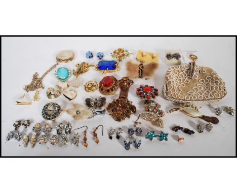 A collection of vintage 20th Century costume jewellery brooches to include a Scottish Grouse foot brooch, earrings both clip 