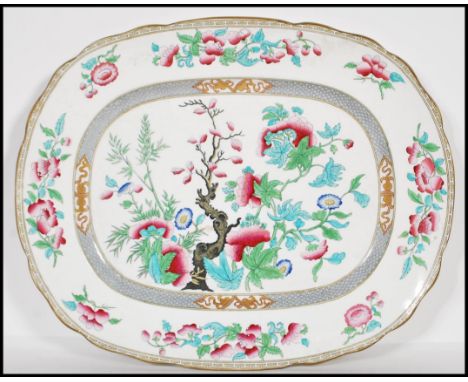 A large 19th Century ceramic centrepiece meat platter in the indian tree pattern, transfer printed with hand colouring having