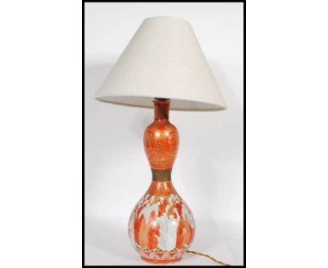 A 20th Century Japanese Kutani ceramic table lamp of gourd form, transfer printed with a thousand faced design with gilt deco