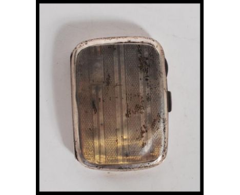 An Art Deco silver hallmarked cigarette case of rectangular bowed form with engine turned stripe decoration and push button c