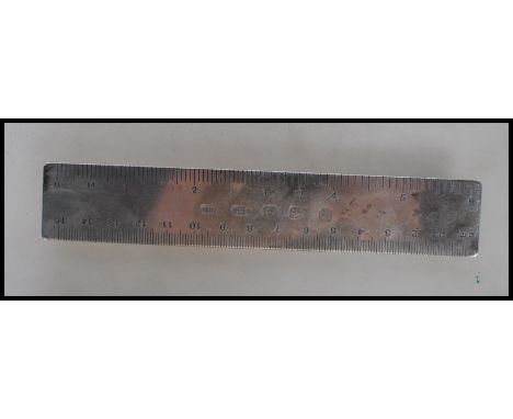 A silver hallmarked ruler measuring in cm from zero to fifteen and in inches from zero to six. Hallmarks for Birmingham date 