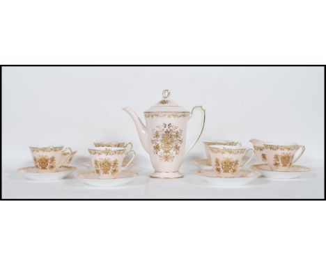 A vintage Noritake bone china coffee service having a pink ground with gilt decoration. Consists of tall coffee pot with coff