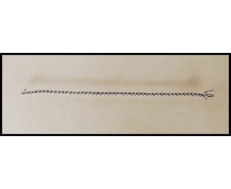 A hallmarked 9ct white gold bracelet having illusion set diamonds with a push button clasp. Approx 0.25 points. Measures 7 in