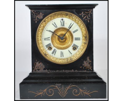 An antique late 19th / early 20th century Victorian slate mantel clock. The dial being enamel, with gilt brass decoration. Th