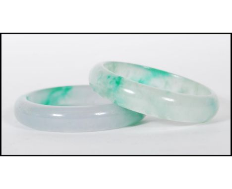 A pair of 20th century Chinese jade slave bangles, each bangle of roundel form. Measures&nbsp;internal 6cm diameter.&nbsp;