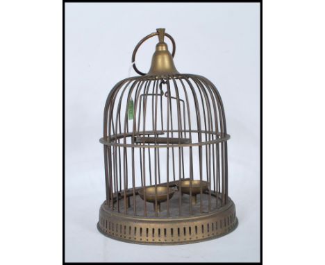 A Victorian-style brass bird cage, being of cylindrical form with domed top having a suspension ring to the finial. Small doo