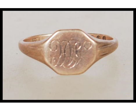 A hallmarked 9ct gold signet ring having an octagonal head engraved with initials 'M H'. Hallmarked London 2002. Weight 2.1g.