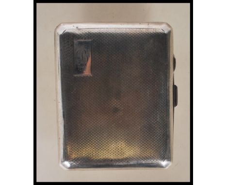 A circa 1930's Art Deco silver cigarette case of curved rectangular form having engine turned decoration with push button cla