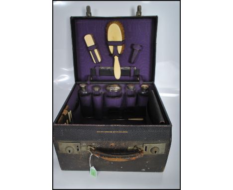 A early 20th Century fitted silver vanity set consisting of two bone handled brushes and silver handled comb hallmarked for B