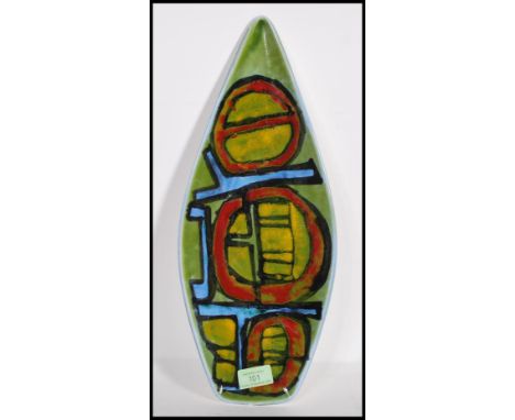 A vintage 1970's Poole pottery Delphis platter of tear drop form having green, yellow and red geometric decoration. Monogramm