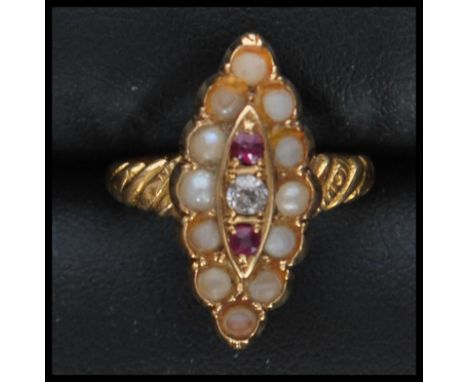 A 9ct gold seed pearl, ruby and diamond ring in lozenge set channel mount. The central round cut diamond approx 3pnts. Total 