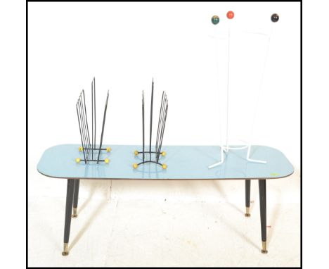 A retro vintage mid 20th Century atomic coffee table with a vivid blue top raised on splayed tapering supports together with 