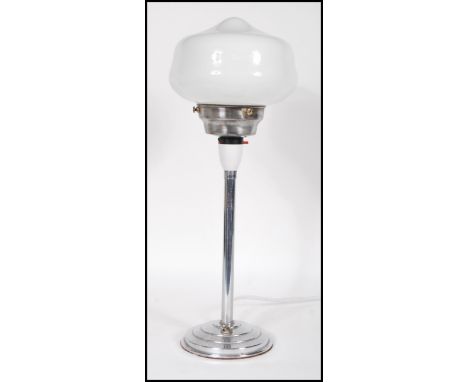 An early 20th Century Art Deco 1920's chrome table lamp with original brass flik switch to circular stepped base having opali