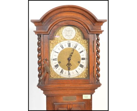 An early 20th Century Edwardian Jacobean revival panel oak cased grandmother clock. The trunk with geometric carved embellish