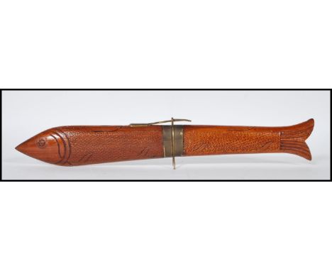 A 20th Century knife and fork carving set, the set carved from hard wood and modelled as a Carp having a bronzed safety clasp
