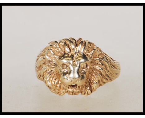 An English hallmarked 9ct gold lion mask ring having pierced eyes and mouth. Assay marks for London. Weight 7.4g. Size R.&nbs