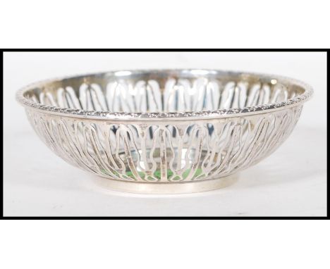 An English hallmarked trinket bowl having pierced decoration to the sides and garland decoration to the rim. Hallmarked Birmi