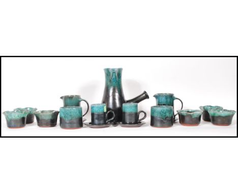 A vintage Woburn studio pottery coffee set having green mottled turquoise glaze rims to include coffee pot, two jugs, coffee 