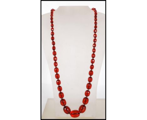 A cherry bakelite necklace having fifty five graduating oval faceted cut&nbsp;beads, with spring ring clasp. Measures 30 inch