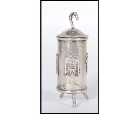 A Chinese silver travelling pepperette / spice pot of cylindrical form having raised characters to the sides raised on bamboo